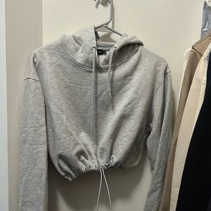 PRETTYLITTLETHING gray cropped sweatshirt. Size M. Fits TTS. Cinched waist